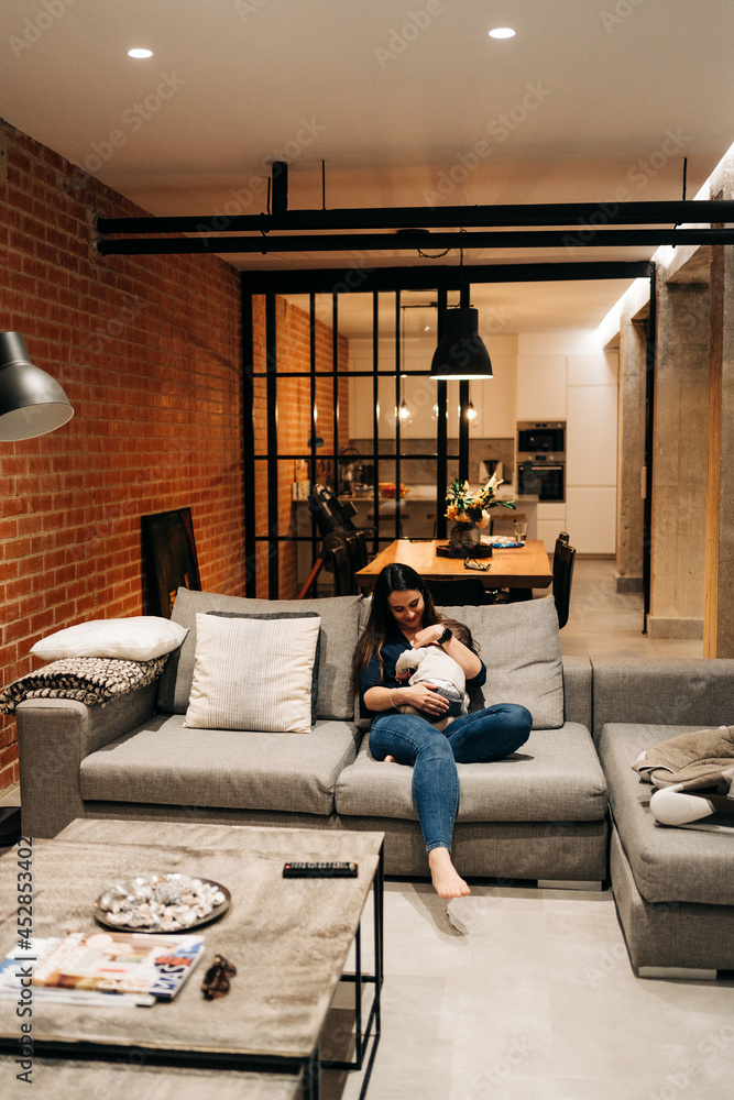Obraz premium young family at home cuddling while baby is taking a nap