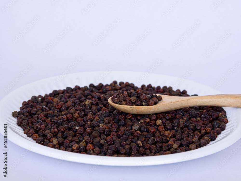 close up of Black pepper on white plate close up of Black pepper on white plate