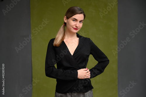 business woman portrait in studio on gray-green background