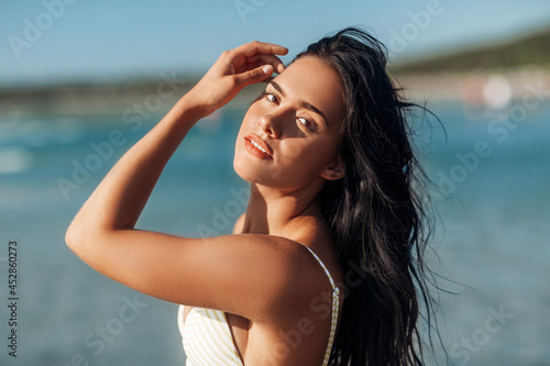 people, summer and swimwear concept - beautiful young woman in bikini swimsuit on beach