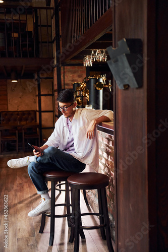 One person. Man in casual clothes sitting in the pub