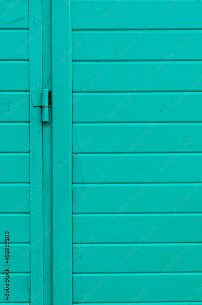 Green part of metal door with door hinge Green part of metal door with door hinge
