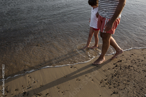 Father and son walking at the beach