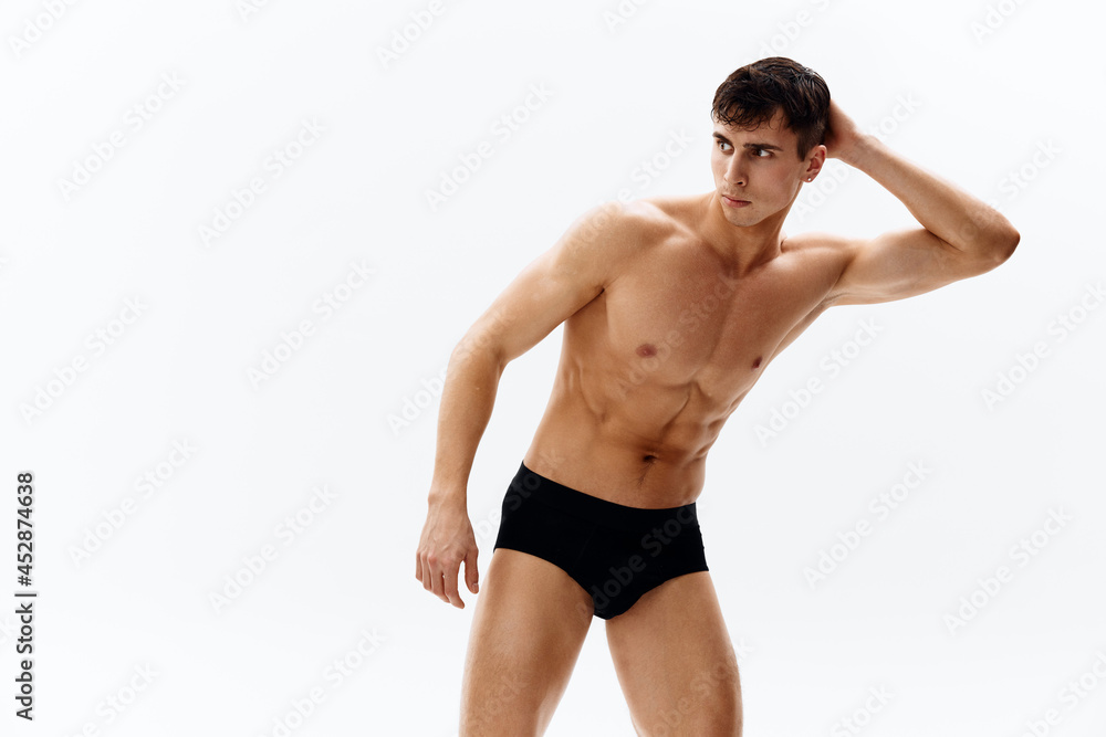 man in dark shorts cropped view Studio dark background man in dark shorts cropped view Studio dark background
