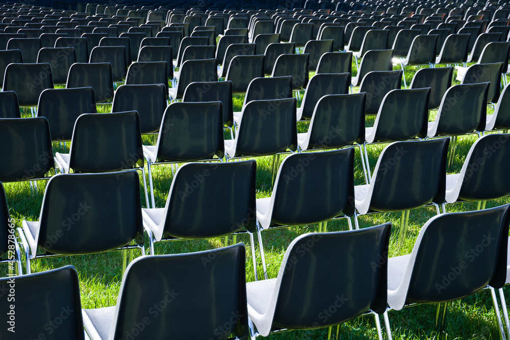 Fototapeta premium rows of empty chairs on the lawn abroad for entertainment