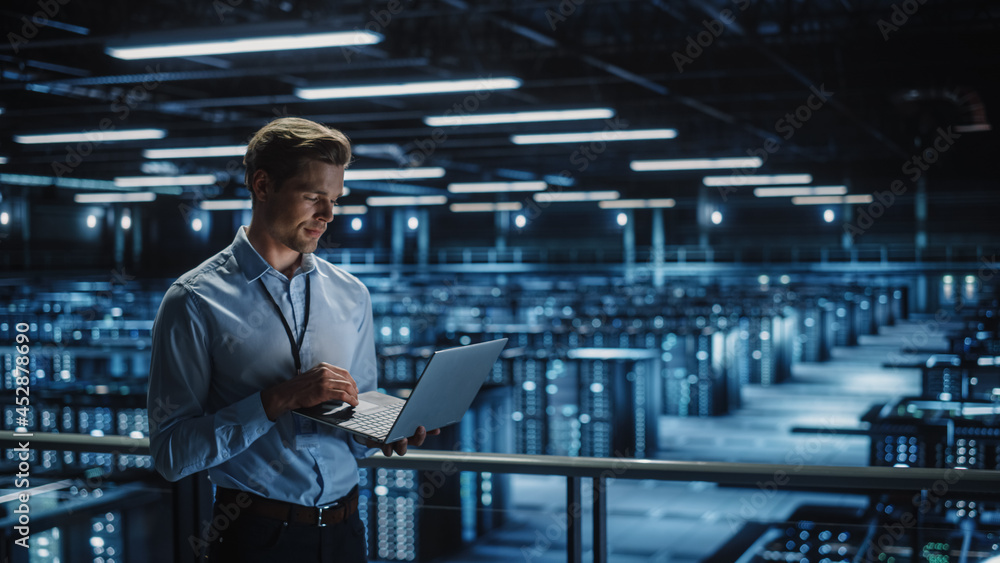 Data Center Specialist Engineer Using Laptop Computer. Server Farm Cloud  Computing Facility with Male Maintenance Administrator Working. Data  Protection Network for Cyber Security. Stock Photo | Adobe Stock