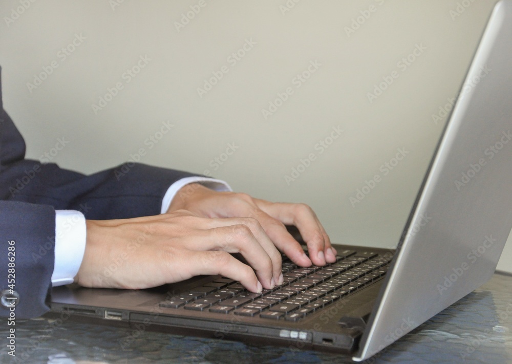man in business suit typing laptop, selective focus man in business suit typing laptop, selective focus