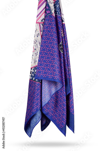 Subject photo of bright scarf with colorful fashion design. Stylish silk neckerchief is hanging on the white background. 