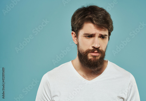 Man in a white t-shirt irritated facial expression Studio