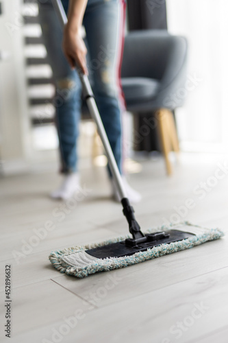 Wallpaper Mural Close up of legs of female cleaner mopping flooring standing near a bucket Torontodigital.ca