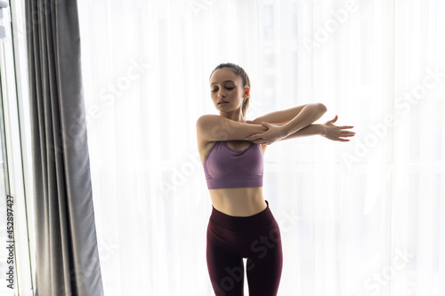 fitness, home and diet concept - smiling young woman streching at home Free Download fitness, home and diet concept - smiling young woman streching at home - GFXLoad
