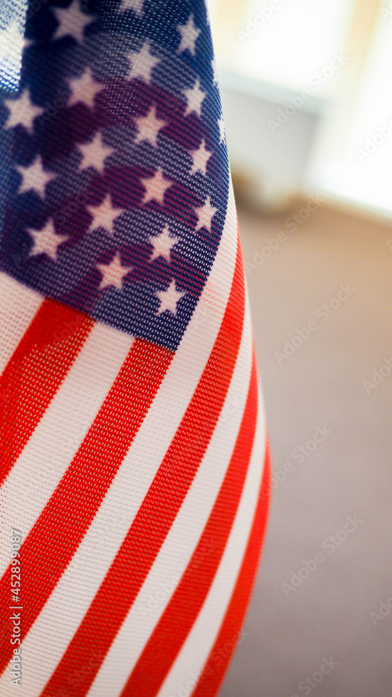 Obraz premium American flag on the table, part overexposed and blurry, the independence of America, the great power USA