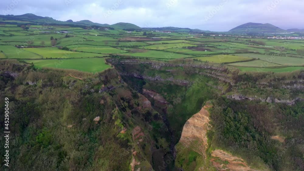 Aerial Forward Scenic View Of Agricultural Filed On Cliff Against Cloudy Sky - Azores, Portugal Aerial Forward Scenic View Of Agricultural Filed On Cliff Against Cloudy Sky - Azores, Portugal