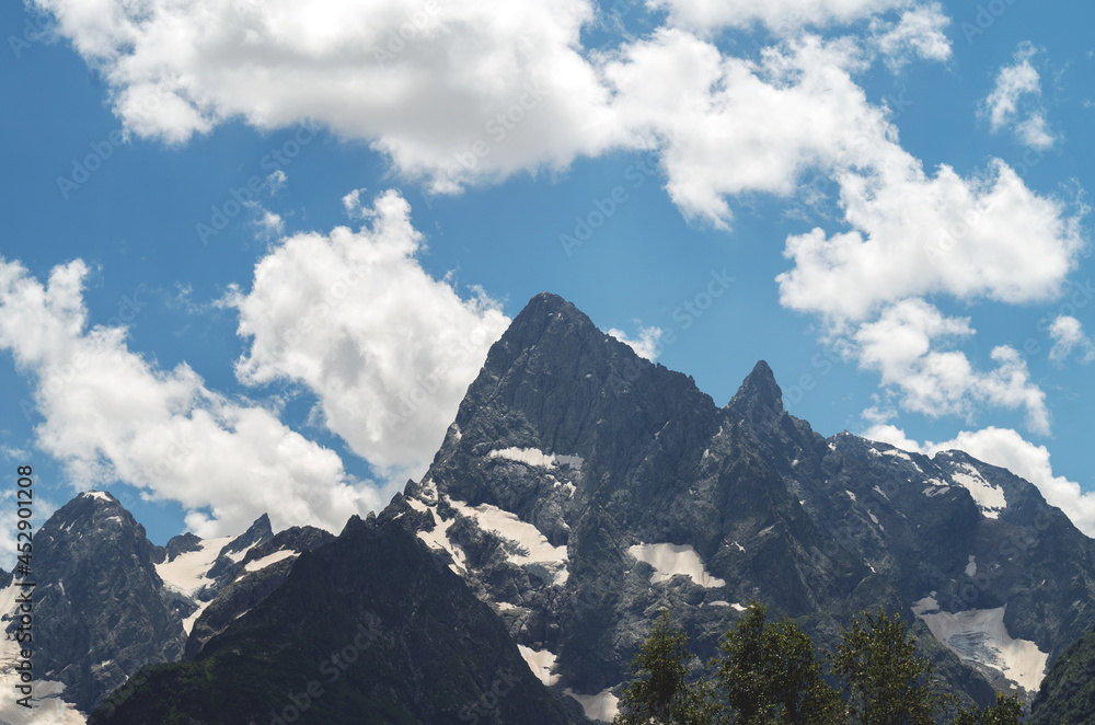 Beautiful mountain landscape with snowy peaks and clouds. Beautiful mountain landscape with snowy peaks and clouds.