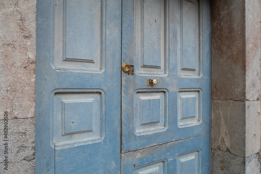 blue wooden door in stone house