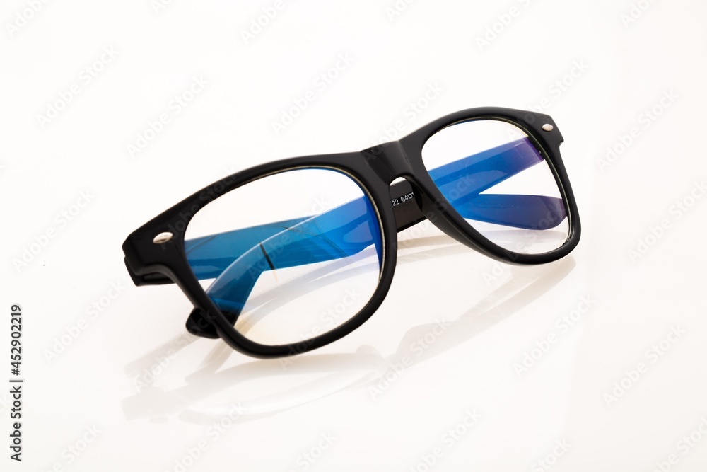 Eyeglasses And Its Reflection Against Light Background Eyeglasses And Its Reflection Against Light Background