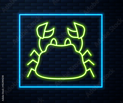 Glowing neon line Crab icon isolated on brick wall background. Vector