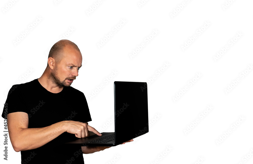 Man looking shocked or annoyed while holding a laptop computer. Isolated on white with copy space. Man looking shocked or annoyed while holding a laptop computer. Isolated on white with copy space.