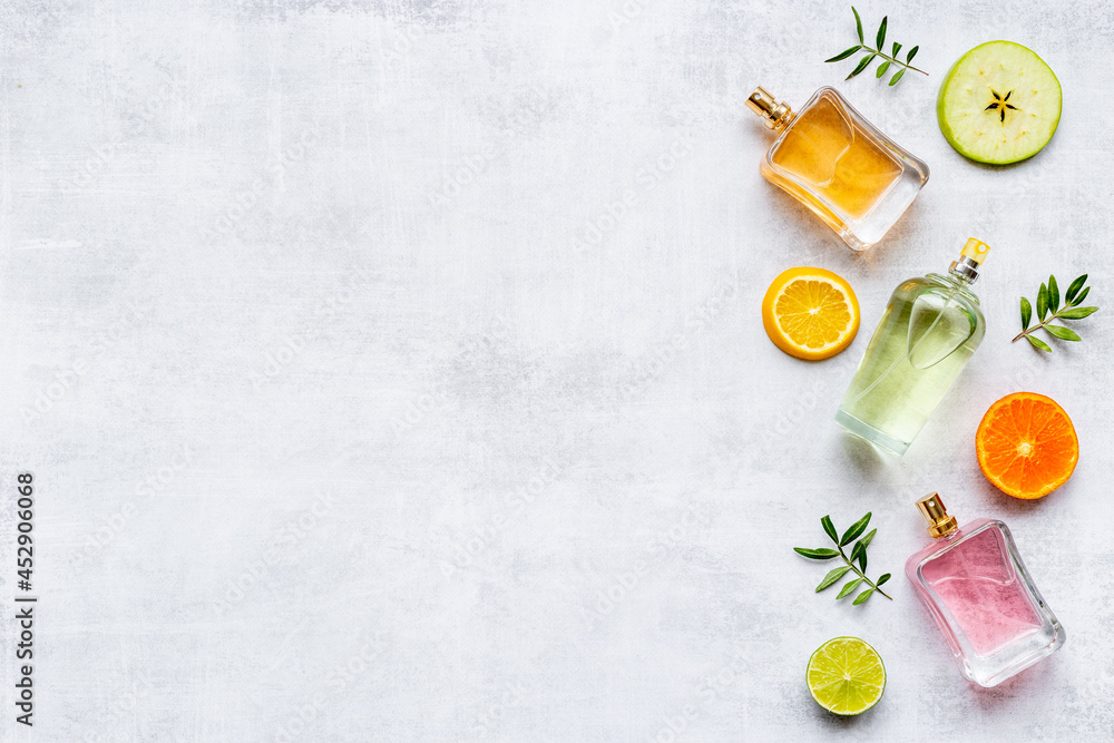 Perfume bottles with flowers leaves and fruits. Overhead view Perfume bottles with flowers leaves and fruits. Overhead view