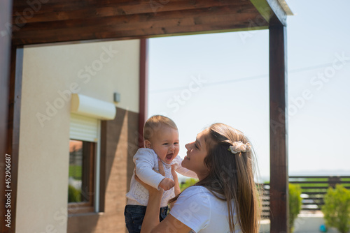 Playing with her daughter while sm iling photo