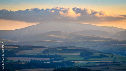 Cloud over The Cheviot from Bowden Doors. Raven's Crag and Bowden Doors are two crag rock formations in Northumberland in North East England, near Belford, designated as a SSSI, popular with climbers photo