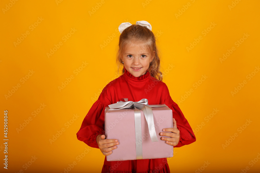 beautiful happy blonde girl in a red dress with a gift box in her hands holiday birthday beautiful happy blonde girl in a red dress with a gift box in her hands holiday birthday