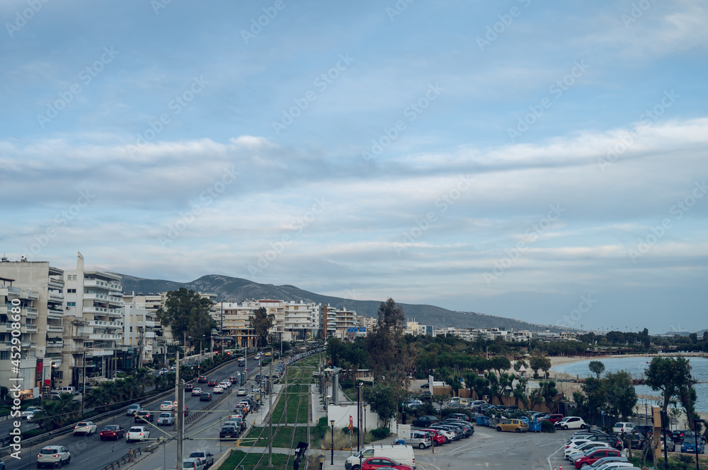 Cityscape of Athens, Greece. Top view from above of road and sea shore. Urban architecture. Mountains on background.