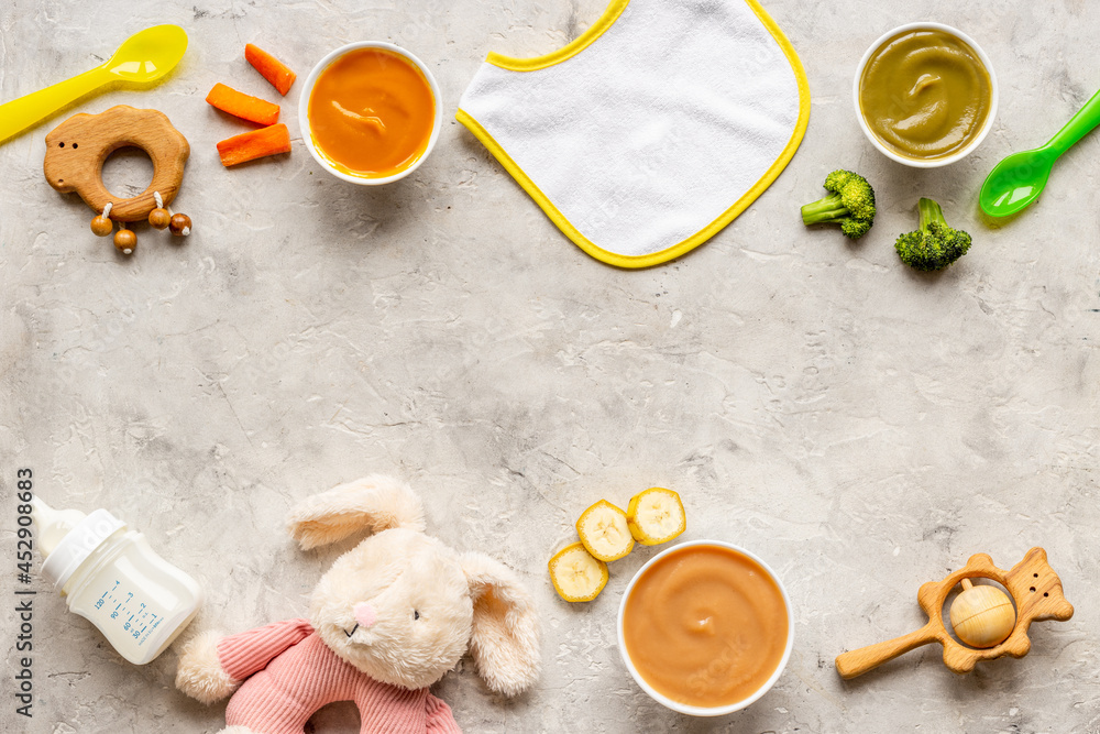 Bowls of various baby food and bottle of milk, top view Bowls of various baby food and bottle of milk, top view