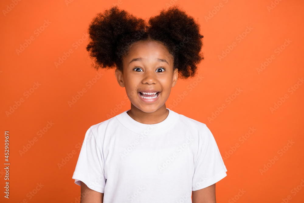 Photo of little funny girl wear white t-shirt isolated on orange color background Photo of little funny girl wear white t-shirt isolated on orange color background