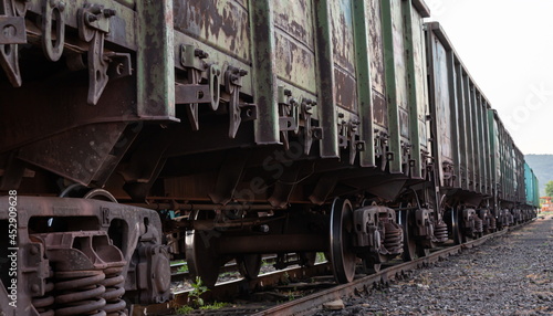 Old rusty railway cars stand on the tracks of the station