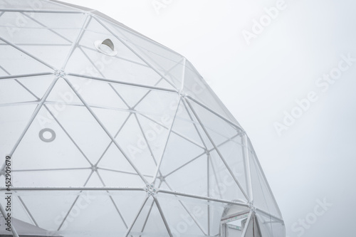 Part of a glass building in the shape of a polyhedron