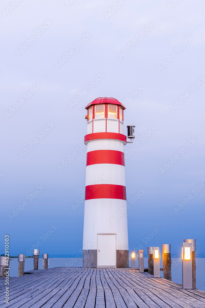 Wooden Pier with Lighthouse in Podersdorf on Lake Neusiedler in Austria at Sunrise.