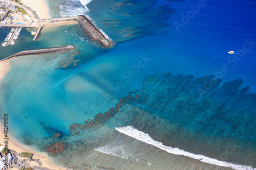 Cristalline blue lagoon waters of West Reunion island and white sand beach