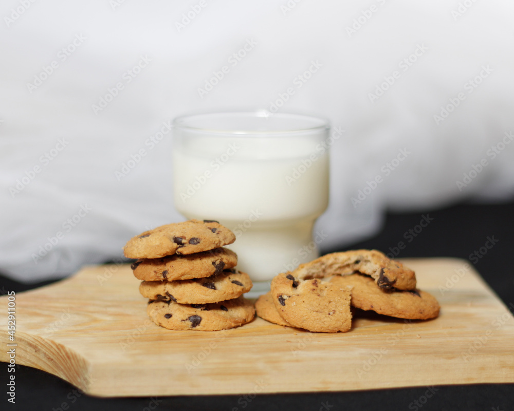 Chocolate biscuits with chocolate chip topping as snacks in the morning, are very popular among children to old age. Biscuits and milk are the perfect combination of food and drink. Biscuit mockup. Chocolate biscuits with chocolate chip topping as snacks in the morning, are very popular among children to old age. Biscuits and milk are the perfect combination of food and drink. Biscuit mockup.