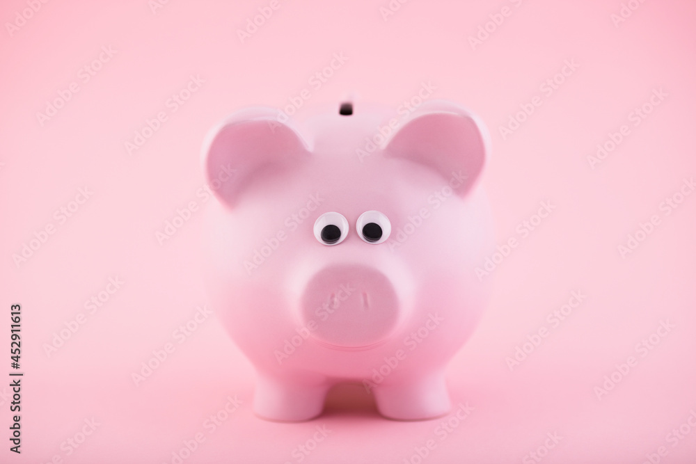 Pink piggy bank on pink background