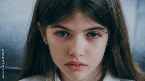 Obraz na płótnie portrait of a sad beautiful girl with blue eyes and tears on her cheeks w salonie