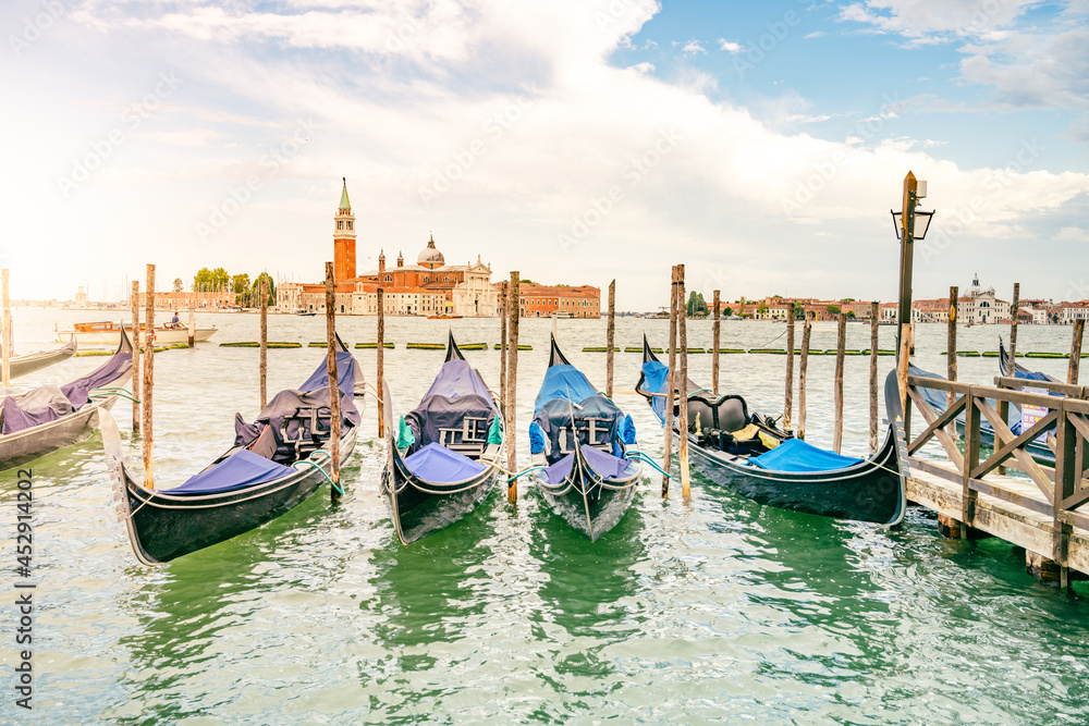 Moored gondolas at St. Mark Square with Church of San Giorgio Maggiore on background. Venice, Italy