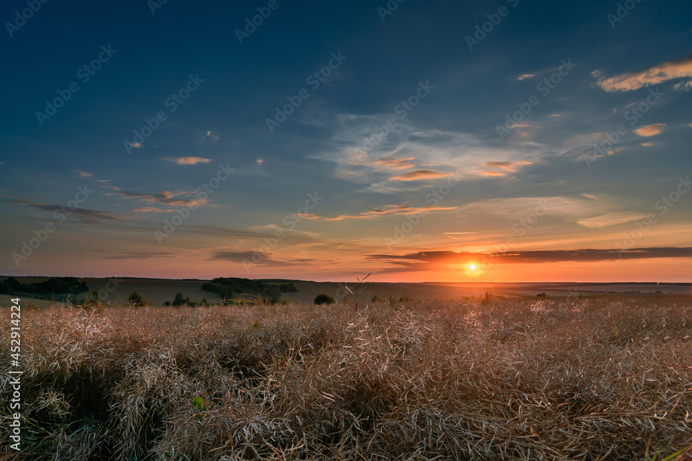 Red sunset over the field in Central Russia