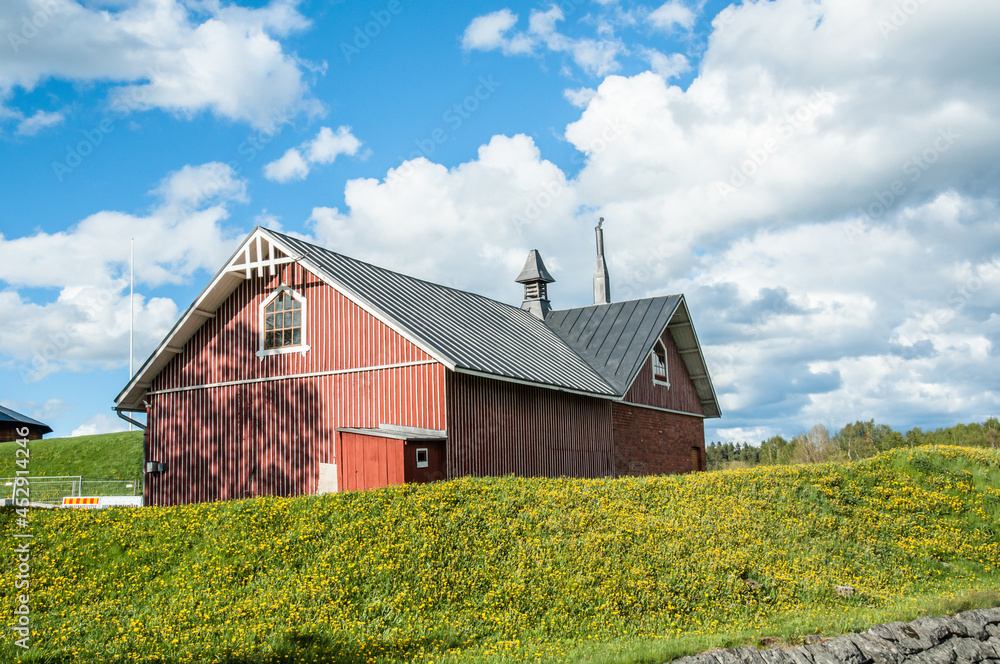 Old wooden building located on grassy hill during sunny day Old wooden building located on grassy hill during sunny day