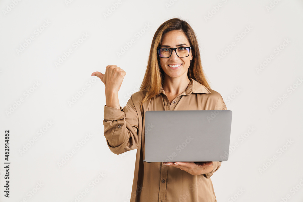 Naklejka premium Happy woman using laptop computer isolated on a white