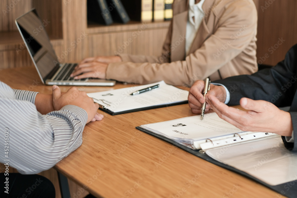Examiner reading a resume during job interview at office Business and human resources concept Examiner reading a resume during job interview at office Business and human resources concept