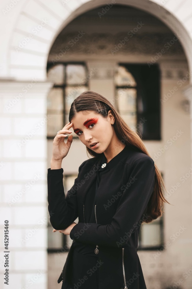 Fototapeta premium beautiful young girl model with bright red makeup.