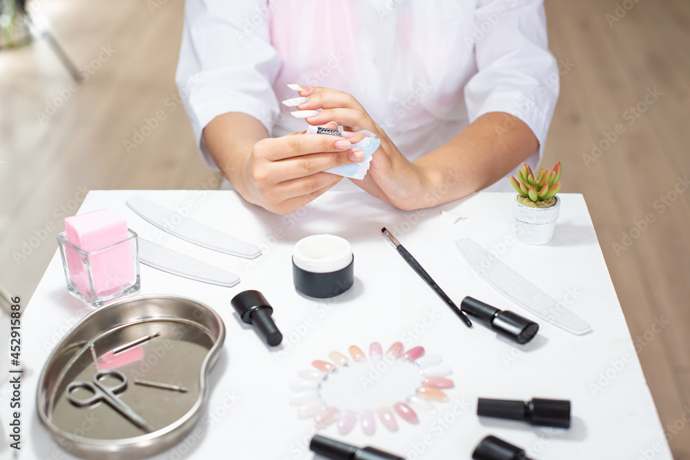 Master performing a professional manicure on herself at beauty salon, on-line manicure training course. Self-care manicure. Beautician student practicing manicure on herself. Nail beauty blogging Master performing a professional manicure on herself at beauty salon, on-line manicure training course. Self-care manicure. Beautician student practicing manicure on herself. Nail beauty blogging