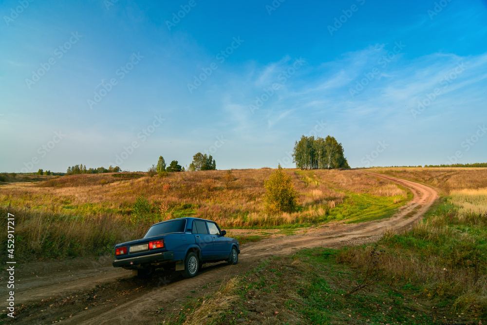 Zhiguli VAZ-2105 car on the country road in the autumn evening