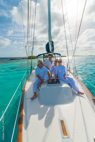 Senior and young couples, family, enjoying sailing trip on a luxury summer holiday vacation, sunny weather and ocean in background, love and romance on a beautiful yacht © TRAVEL EASY