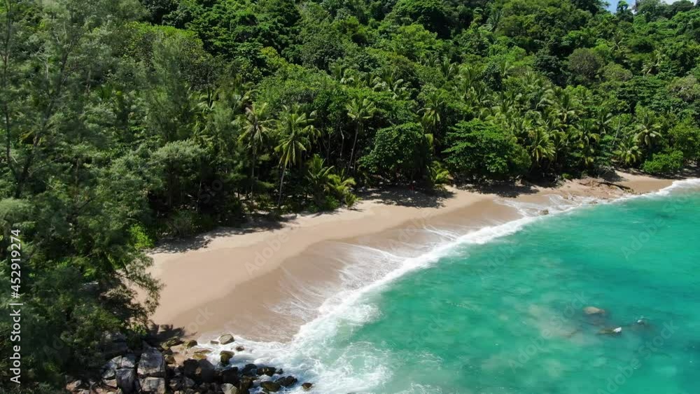 Top view from drone Waves rolling from above breaking beach on morning.Palms trees turquoise sea background.Beautiful sea crystal relax Popular place . Top view from drone Waves rolling from above breaking beach on morning.Palms trees turquoise sea background.Beautiful sea crystal relax Popular place .