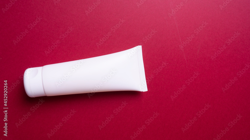 packaging of face or hand cream on red background packaging of face or hand cream on red background
