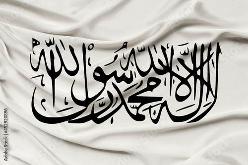 national flag of Afghanistan on silk, text in Arabic I testify that there is no other God but Allah, the concept of the Islamic Emirate of Afghanistan, the restoration of Taliban rule in the country photo