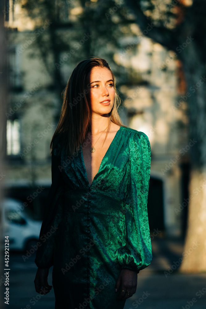 Happy woman in stylish green dress in city Happy woman in stylish green dress in city
