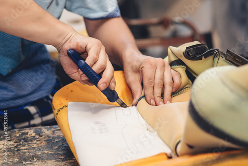 Repair of the old car seat. Car mechanic's hands is using tools.